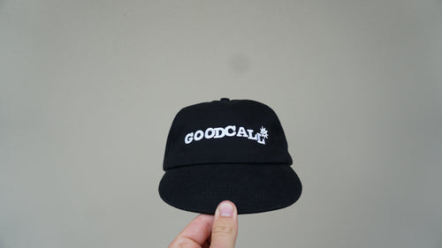Front view of the black GOODCALL hat with white branding
