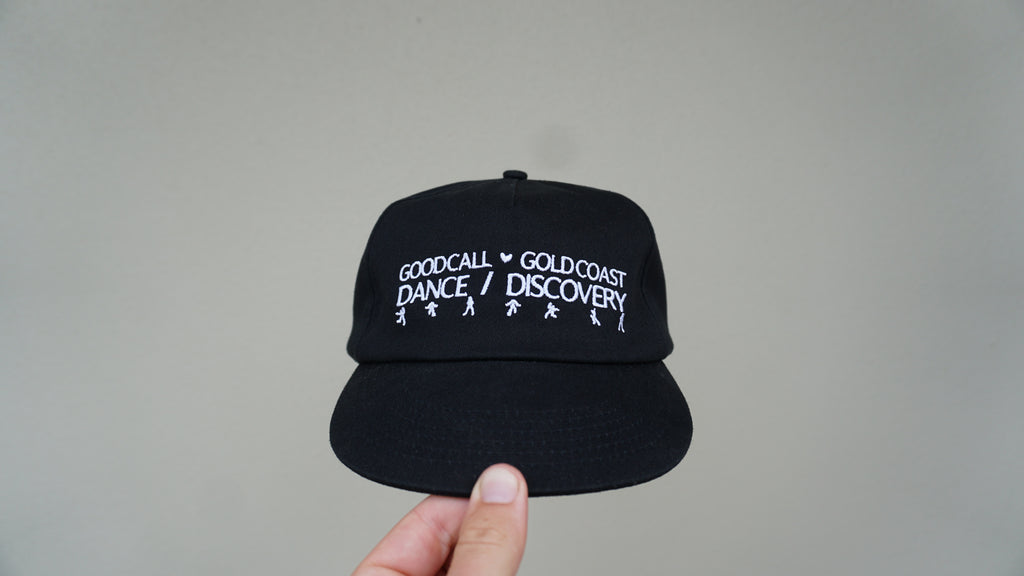 Front view of the black Discovery hat with white Dance / Discovery detailing